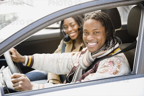 African couple driving in car