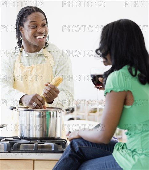 African couple cooking in kitchen