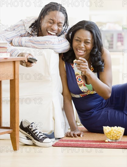 African couple watching television in living room