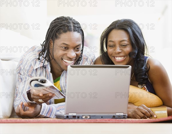 African couple shopping online