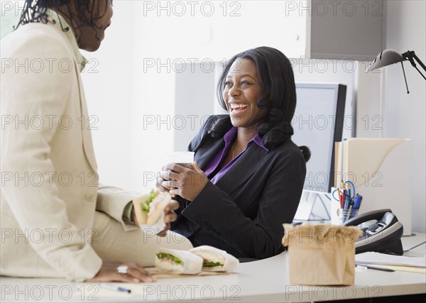African business people laughing at lunch