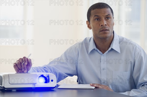 African man working slide projector