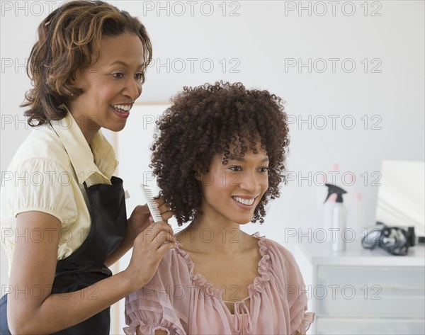 African hairdresser and client