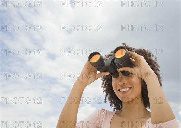 African woman looking through binoculars