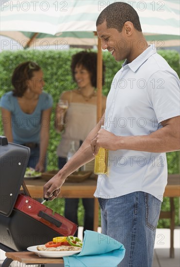 African man and women barbecuing