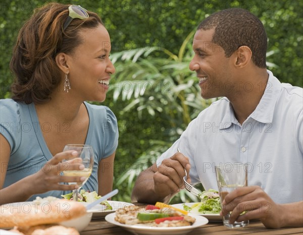 African couple eating on patio