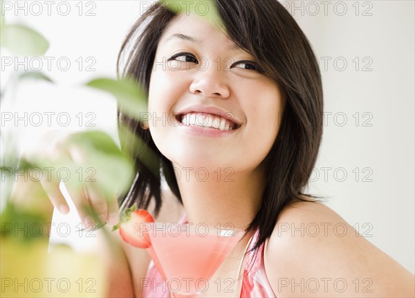 Asian woman drinking pink martini