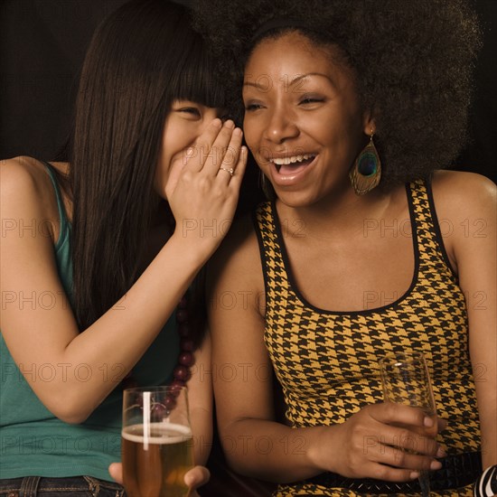 Multi-ethnic friends drinking in nightclub