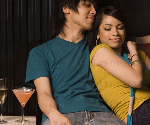 Multi-ethnic couple drinking in nightclub