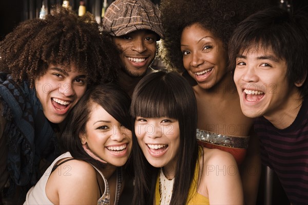 Multi-ethnic friends posing in nightclub