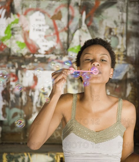 African woman blowing bubbles