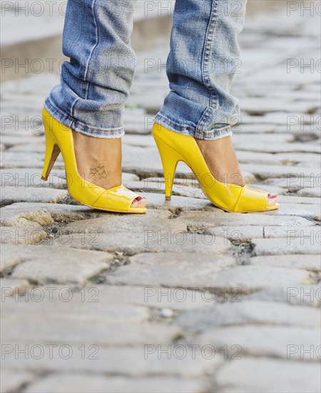 Close up of African woman wearing yellow high heels