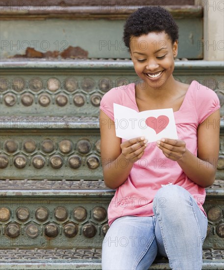 African woman reading Valentine's Day card