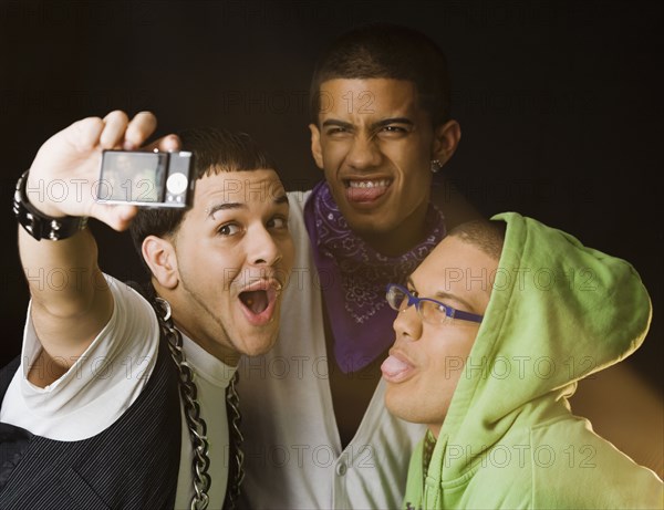 Hispanic friends making faces for self-portrait