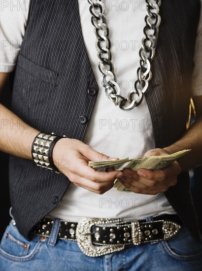 Hispanic man counting stack of money