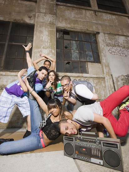 Alternative friends break dancing in urban setting