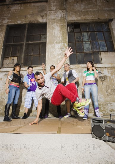 Alternative friends break dancing in urban setting