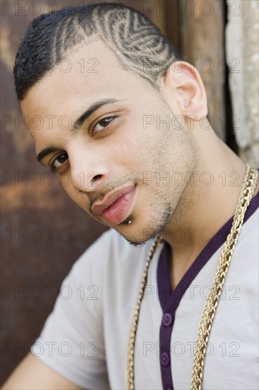 Hispanic teenage boy with design shaved into his head