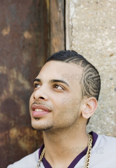 Hispanic teenage boy with design shaved into his head