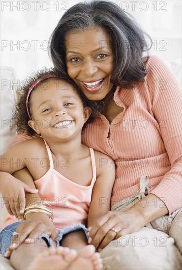 African grandmother hugging granddaughter