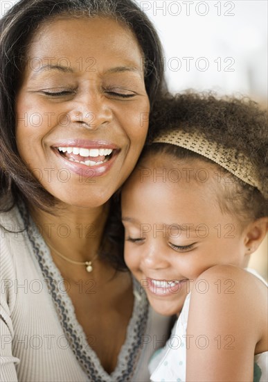 African grandmother hugging granddaughter