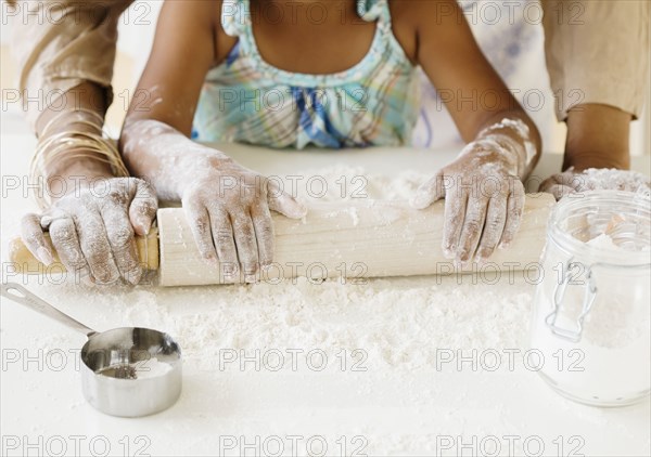 African grandmother baking with granddaughter