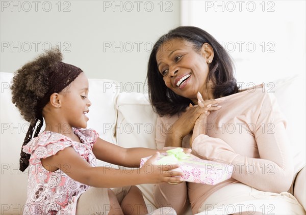 Granddaughter giving African grandmother gift