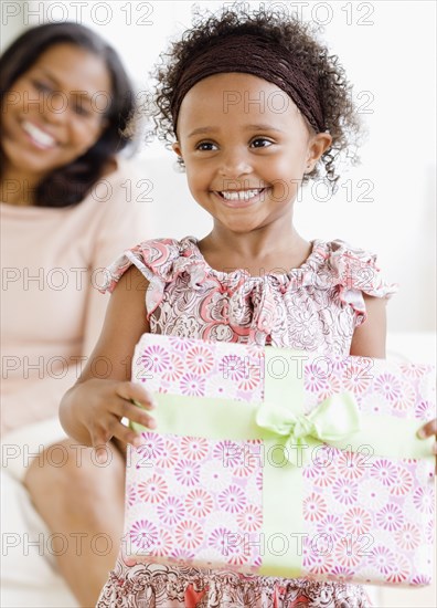 Granddaughter giving African grandmother gift