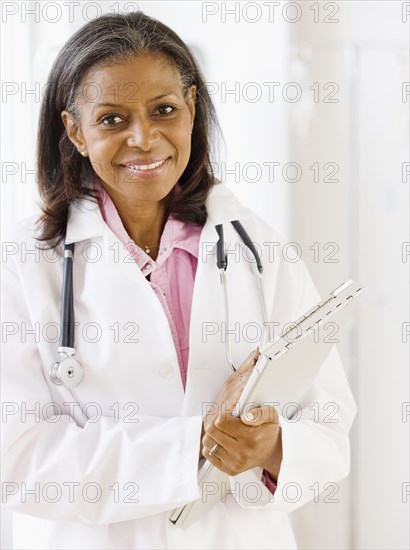 African doctor standing with medical chart