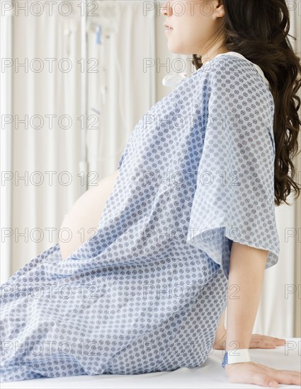 Pregnant Asian woman having checkup in doctor's office