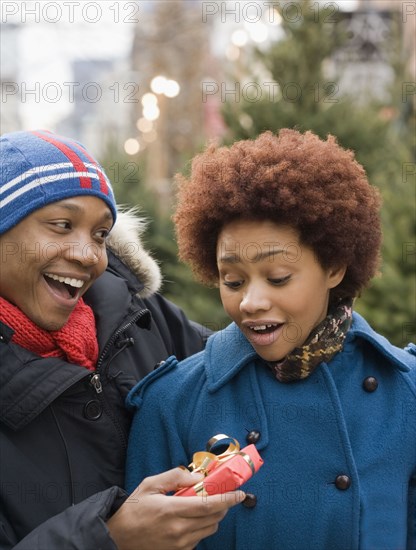 African man giving girlfriend Christmas present