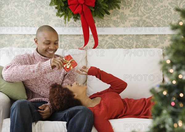 African man giving girlfriend Christmas present