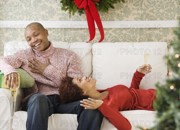 African couple drinking Champagne at Christmastime