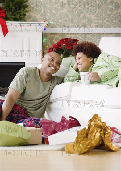 African couple in living room on Christmas morning