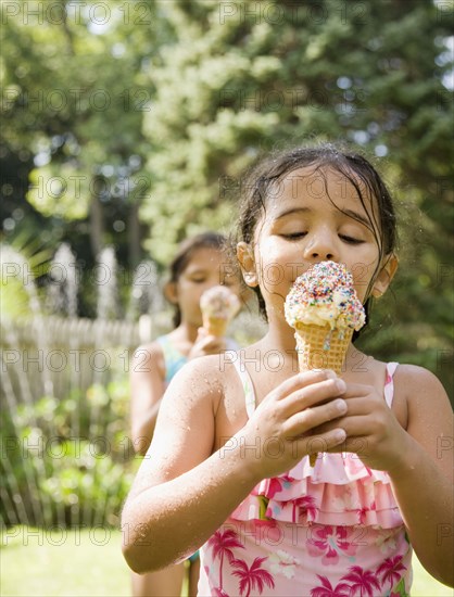 Hispanic girls eating ice cream cones