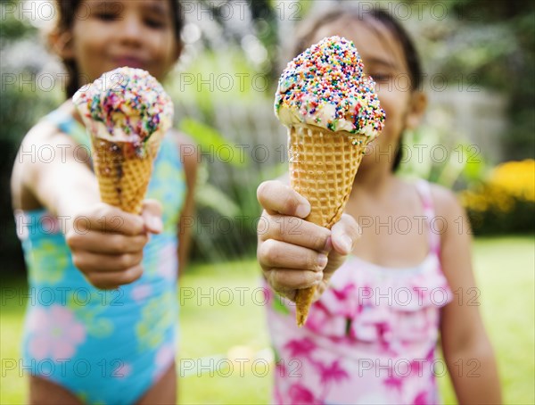 Hispanic girls eating ice cream cones