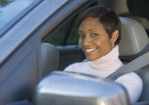 African woman driving car