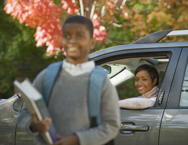 African mother dropping son off at school