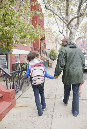 African father and daughter holding hands