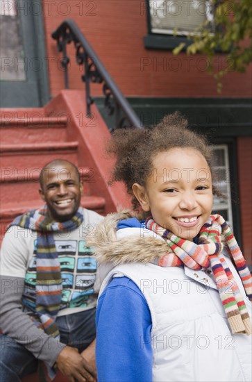 African father and daughter on front stoop