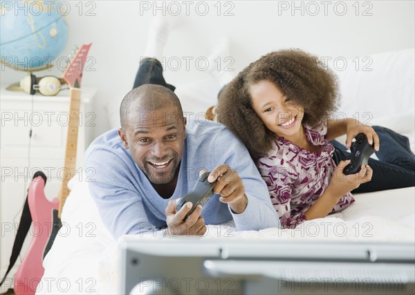 African father and daughter playing video game