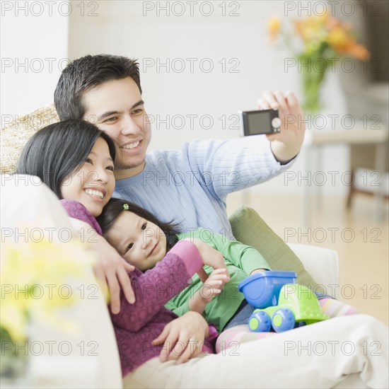 Family on couch posing for photograph