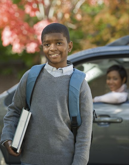 African mother dropping son off at school