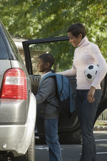 African mother and son leaving for soccer practice