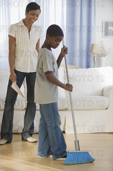 African mother and son doing housework together