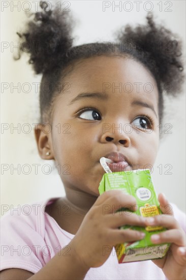 African American girl drinking juicebox