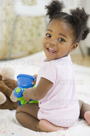 African American girl playing with toy