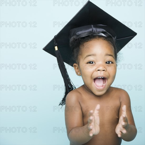 Portrait of African American girl wearing mortarboard