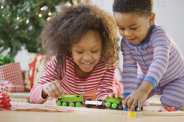 African American brother and sister playing with toy train