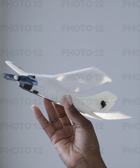 African woman holding airplane model